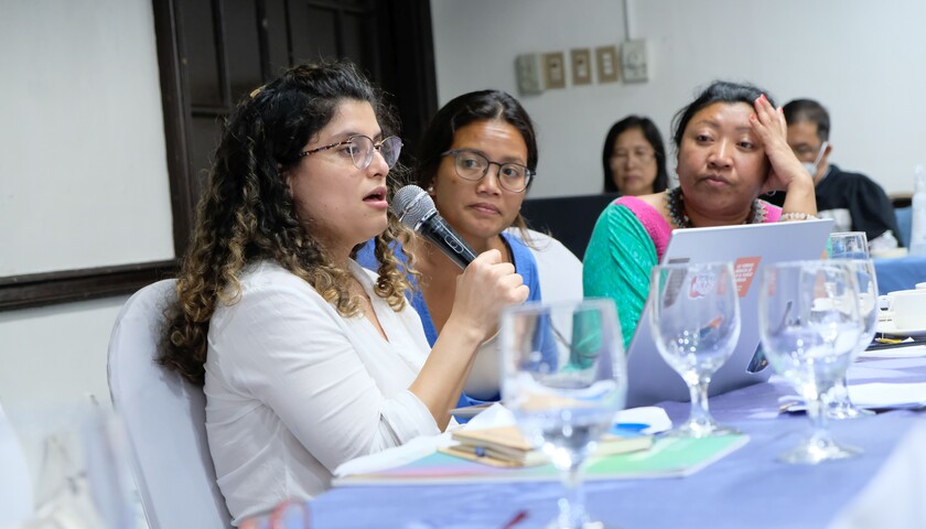 Juliana Rodríguez López speaks into a microphone at the learning exchange in the Philippines