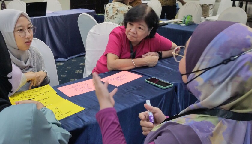 Karen Tanada, director of the Gaston Z. Ortigas Peace Institute, discusses with women at the learning exchange in the Philippines