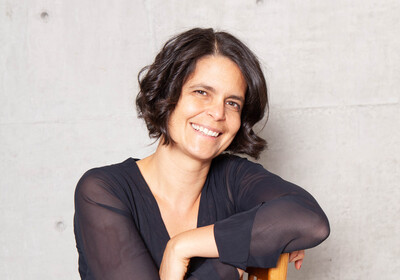 Photo of the new director Deborah Schibler sitting in a chair