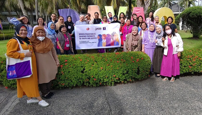 A group of peace activists with a banner at the learning exchange in the Philippines